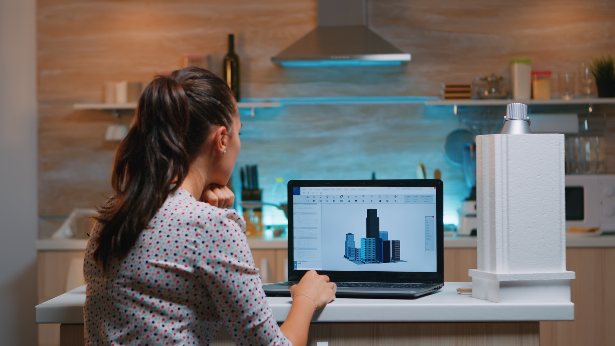 Designer using cad software to design a 3D concept of buildings